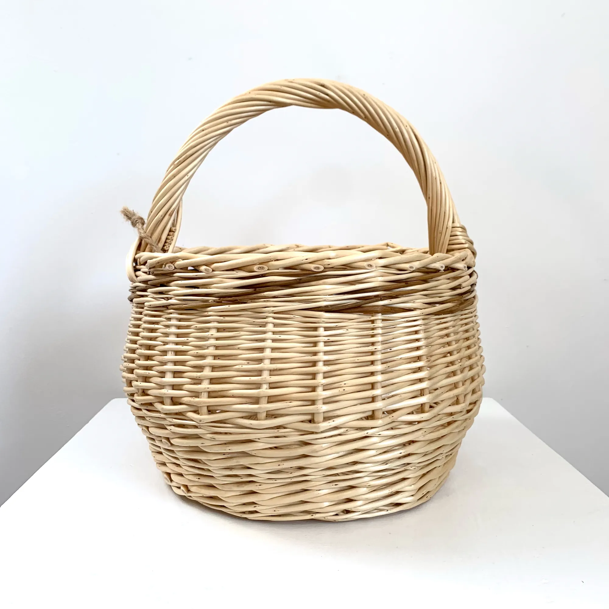 a small white willow foraging or kindling basket with brown willow woven through it also.