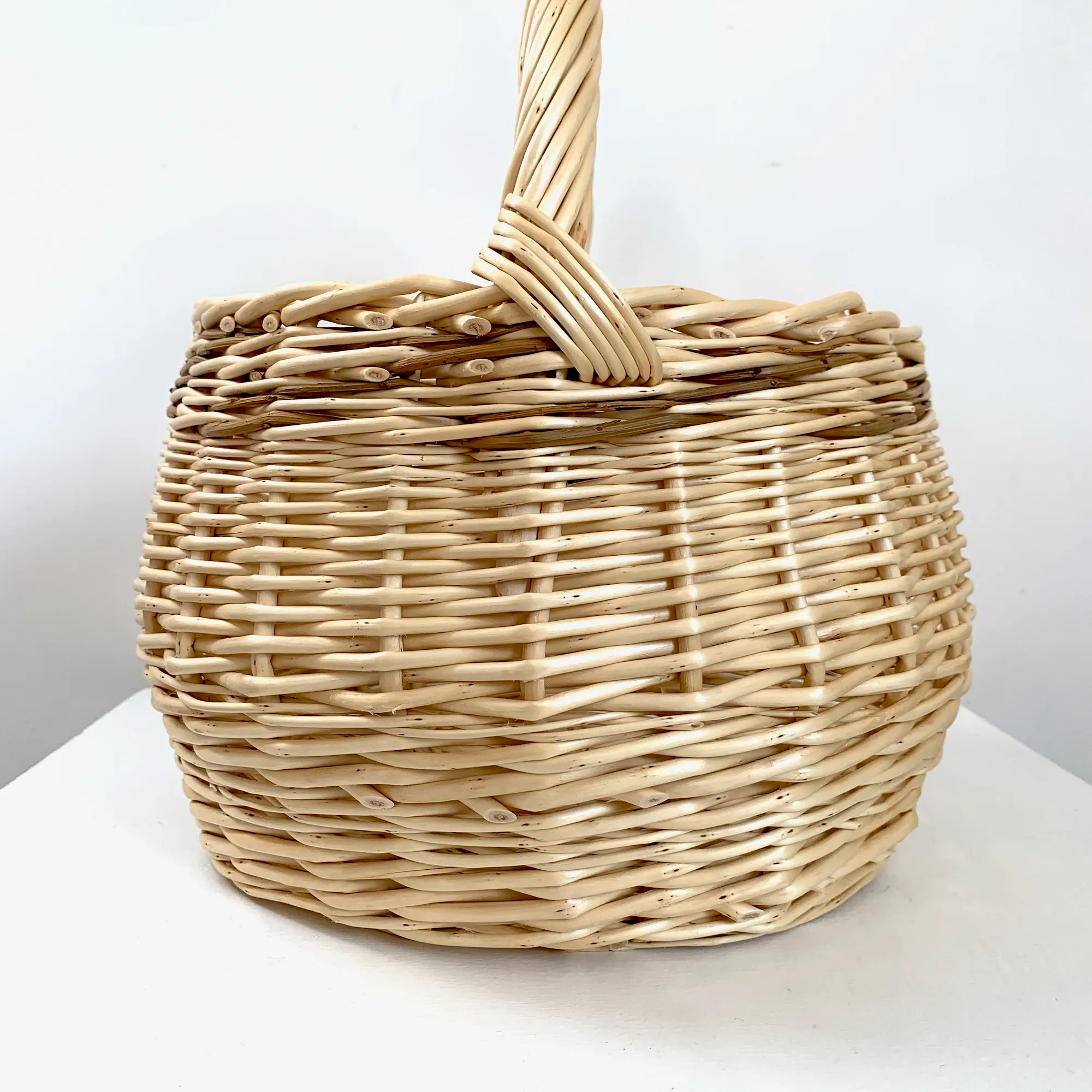 a small white willow foraging or kindling basket with brown willow woven through it also.