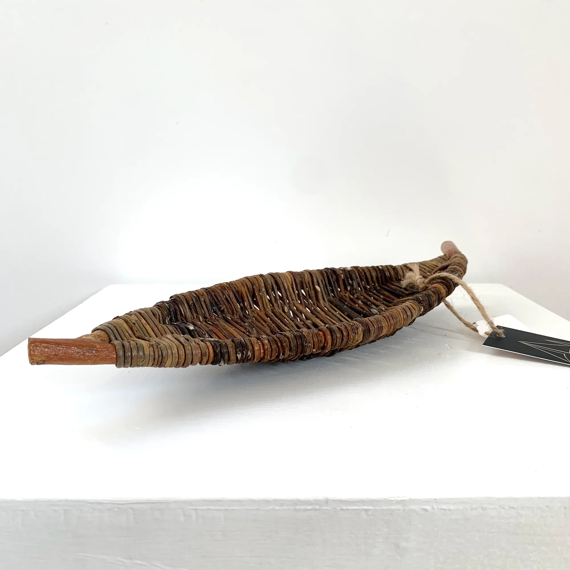 a sculptural long narrow tray in the shape of a leaf made from wild foraged willow