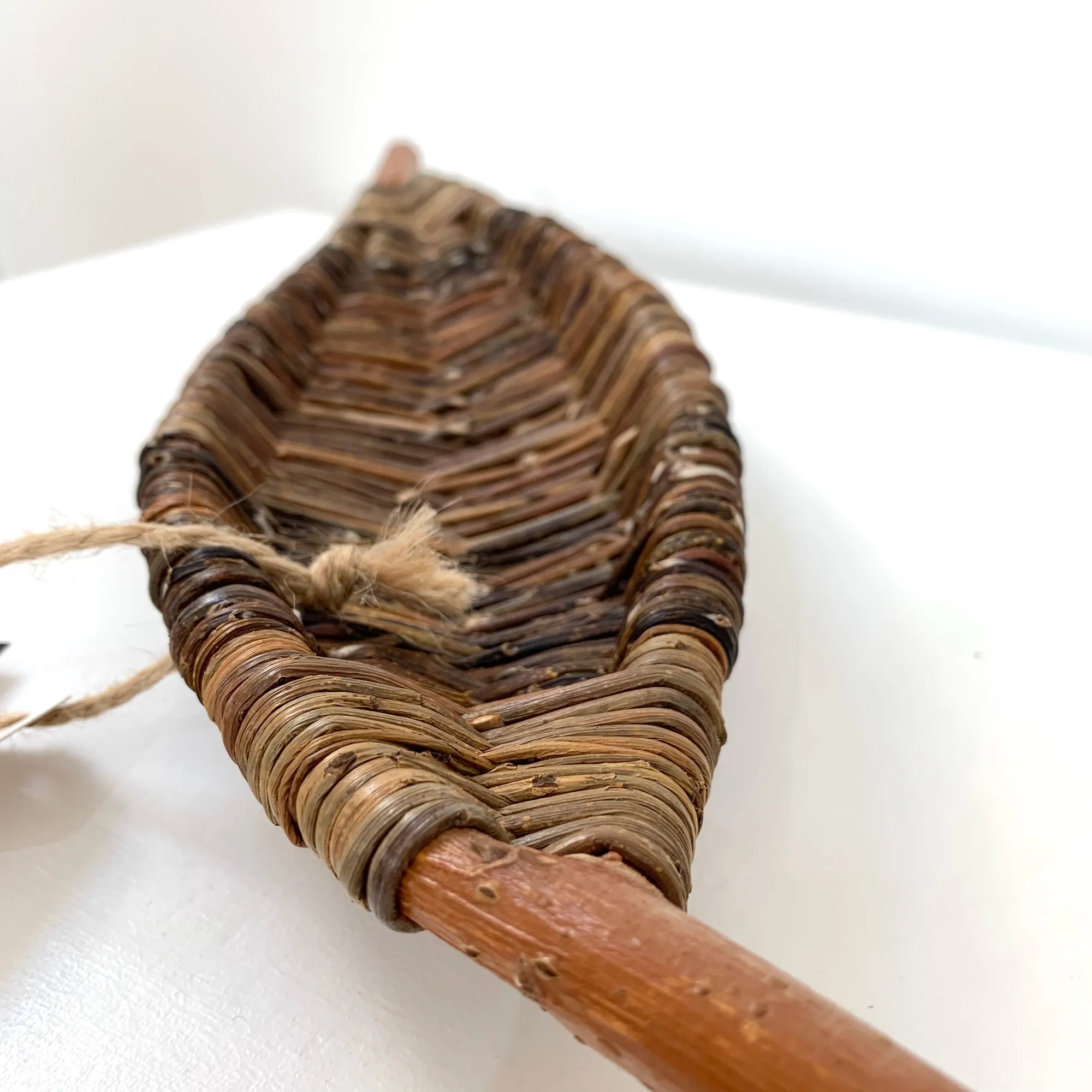 close up of a sculptural long narrow tray in the shape of a leaf made from wild foraged willow