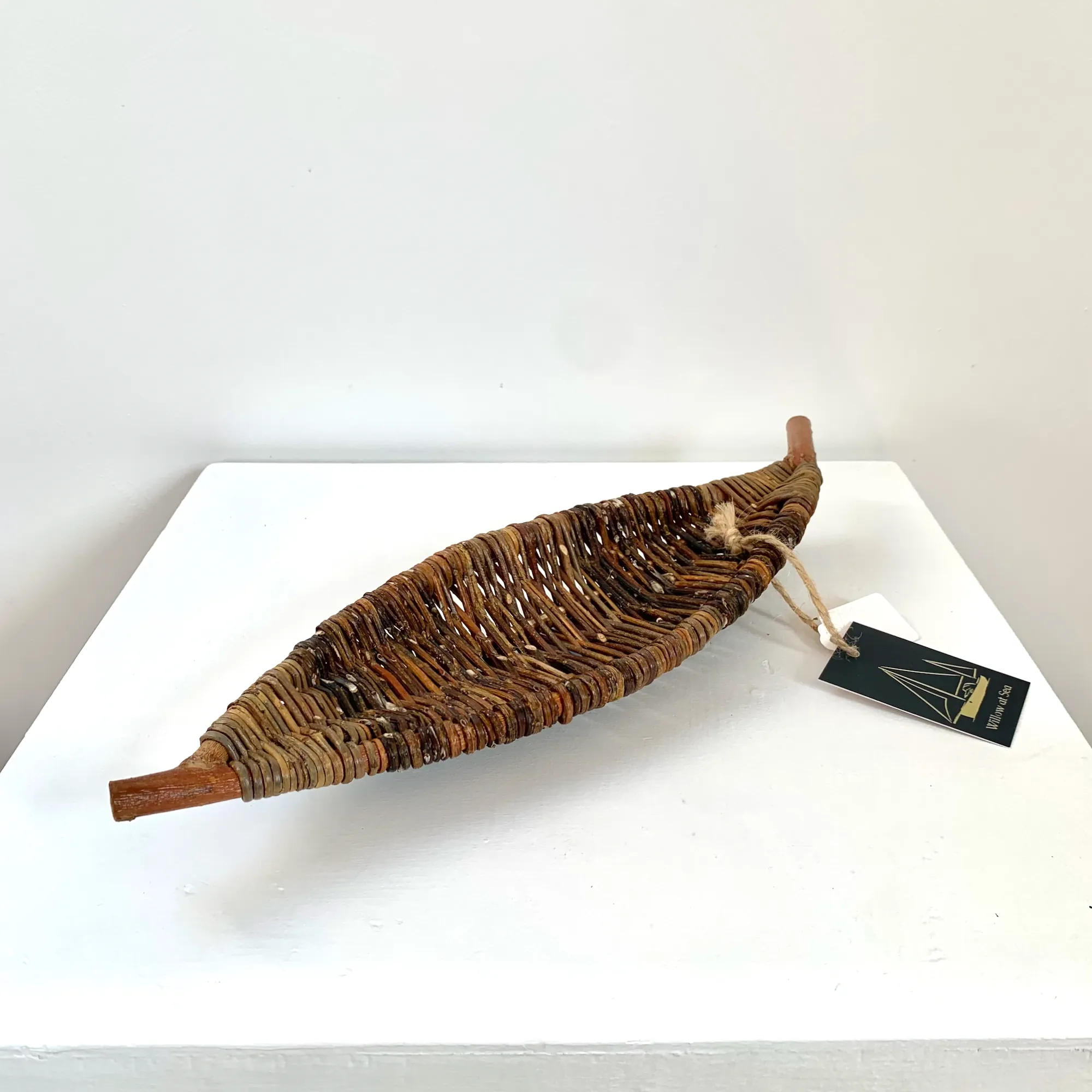 a sculptural long narrow tray in the shape of a leaf made from wild foraged willow