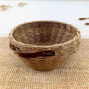 a large willow basket with leather handles